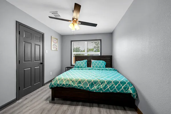 a bedroom with a bed and a window