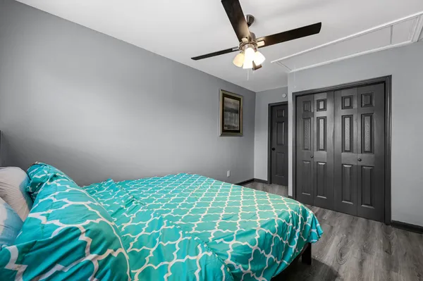 a bedroom with a bed and a chandelier