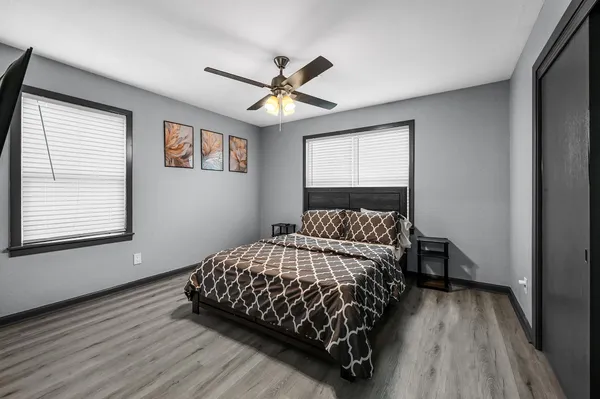 a bedroom with a bed and wooden floor