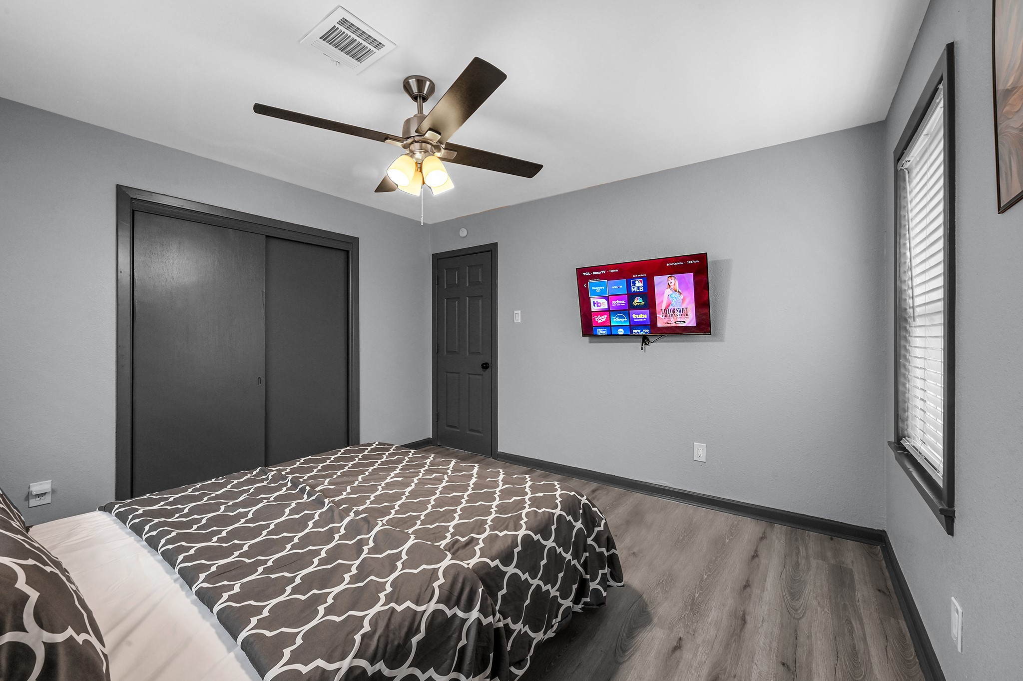 4406 Edison Street Houston, TX 77009 - Photo 38 of 42 a bedroom with a large bed and a chandelier