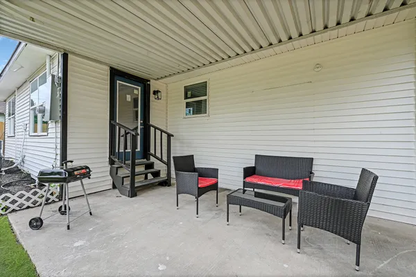 a backyard of a house with outdoor seating