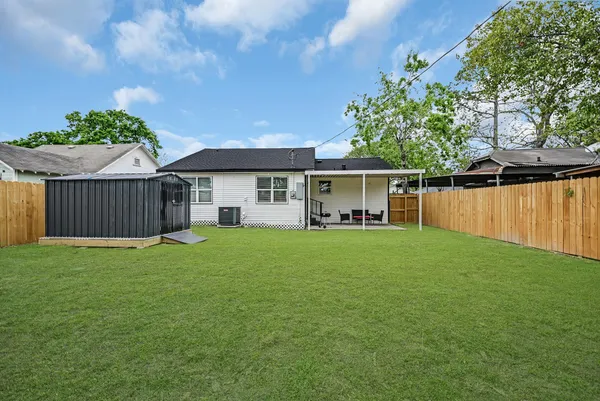 a front view of a house with a garden and yard