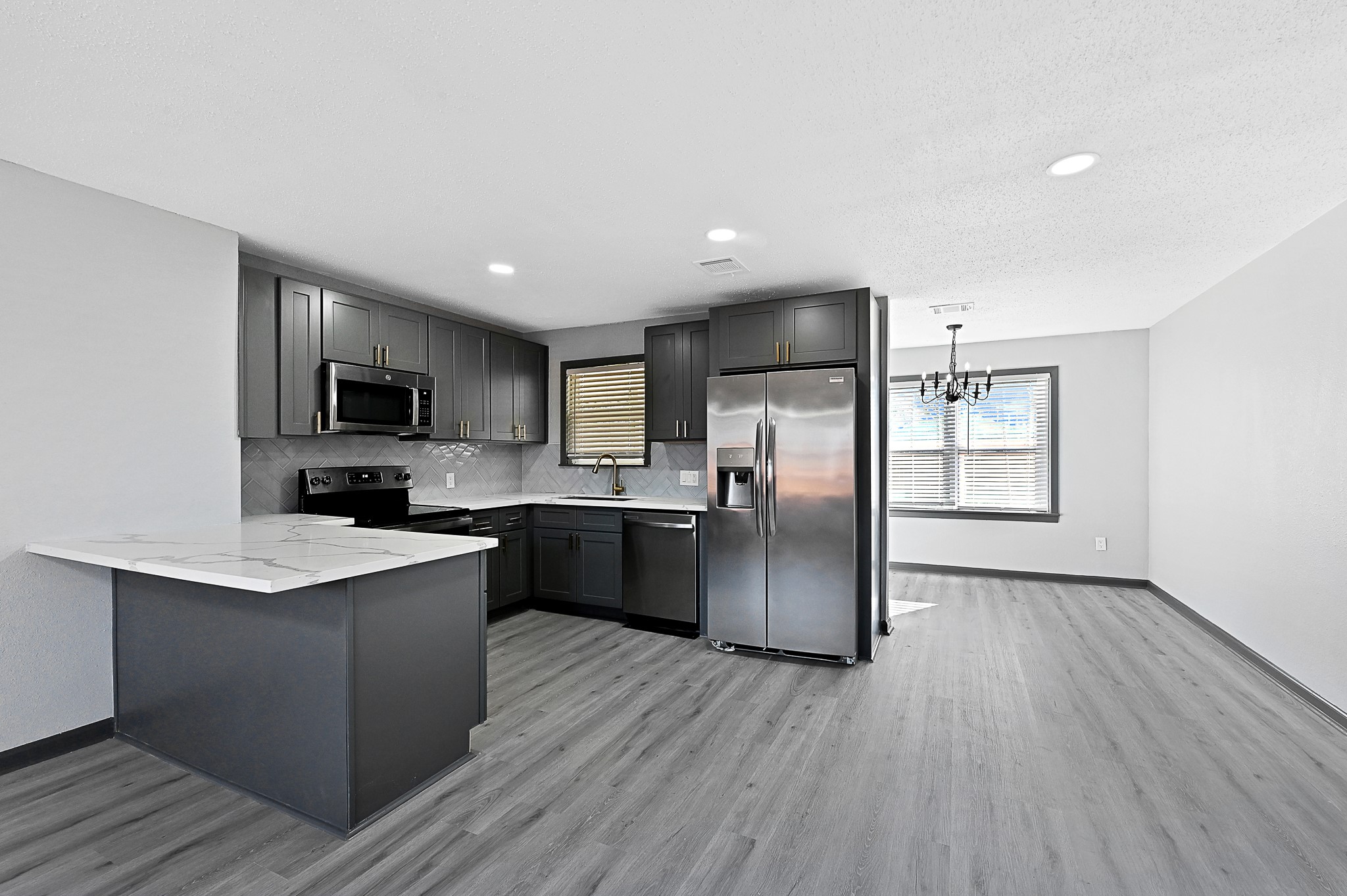 4406 Edison Street Houston, TX 77009 - Photo 6 of 42 a kitchen with stainless steel appliances granite countertop a refrigerator a sink dishwasher a stove top oven a refrigerator with wooden floors and cabinets