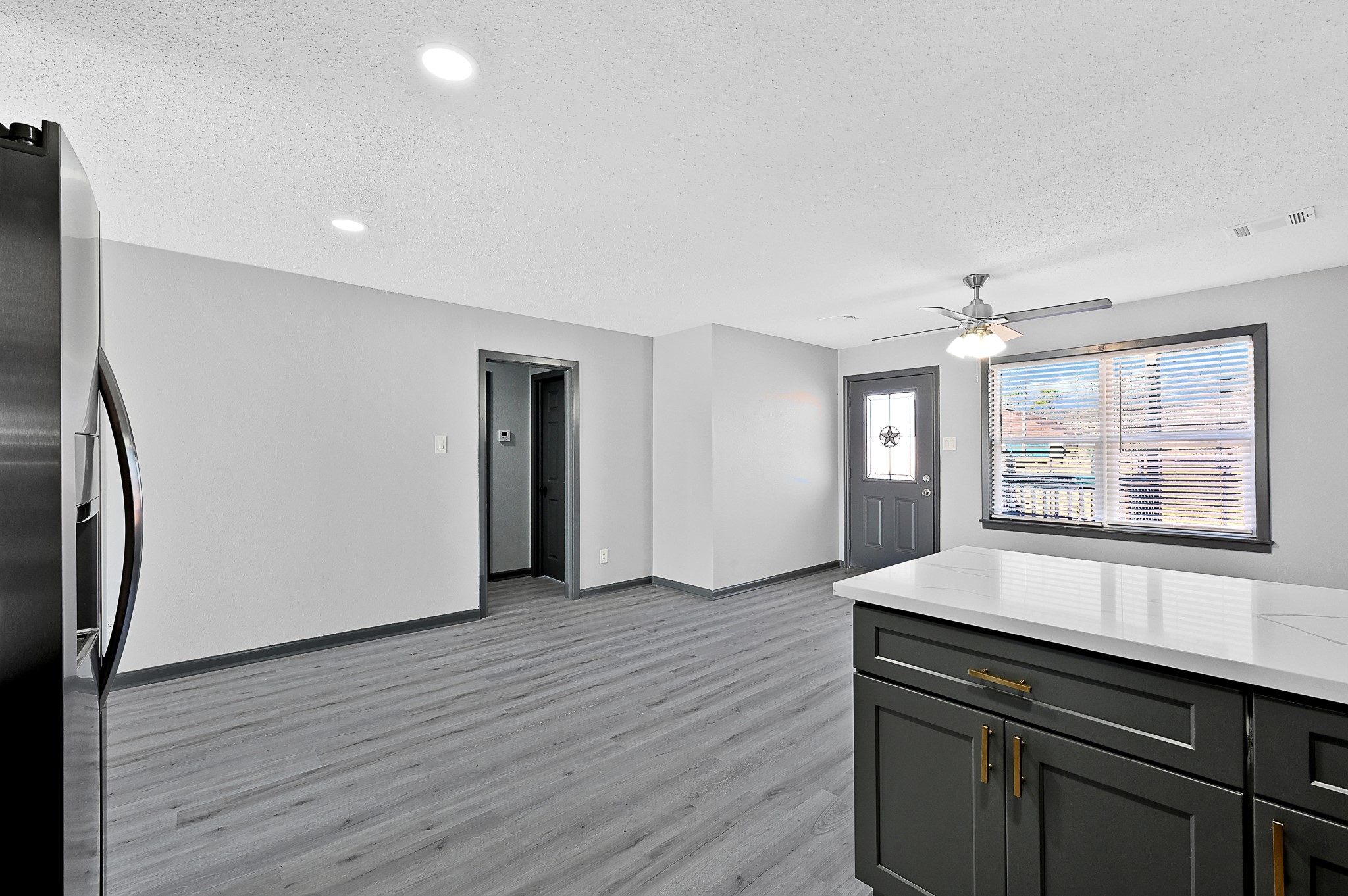 4406 Edison Street Houston, TX 77009 - Photo 7 of 42 an empty room with wooden floor and windows