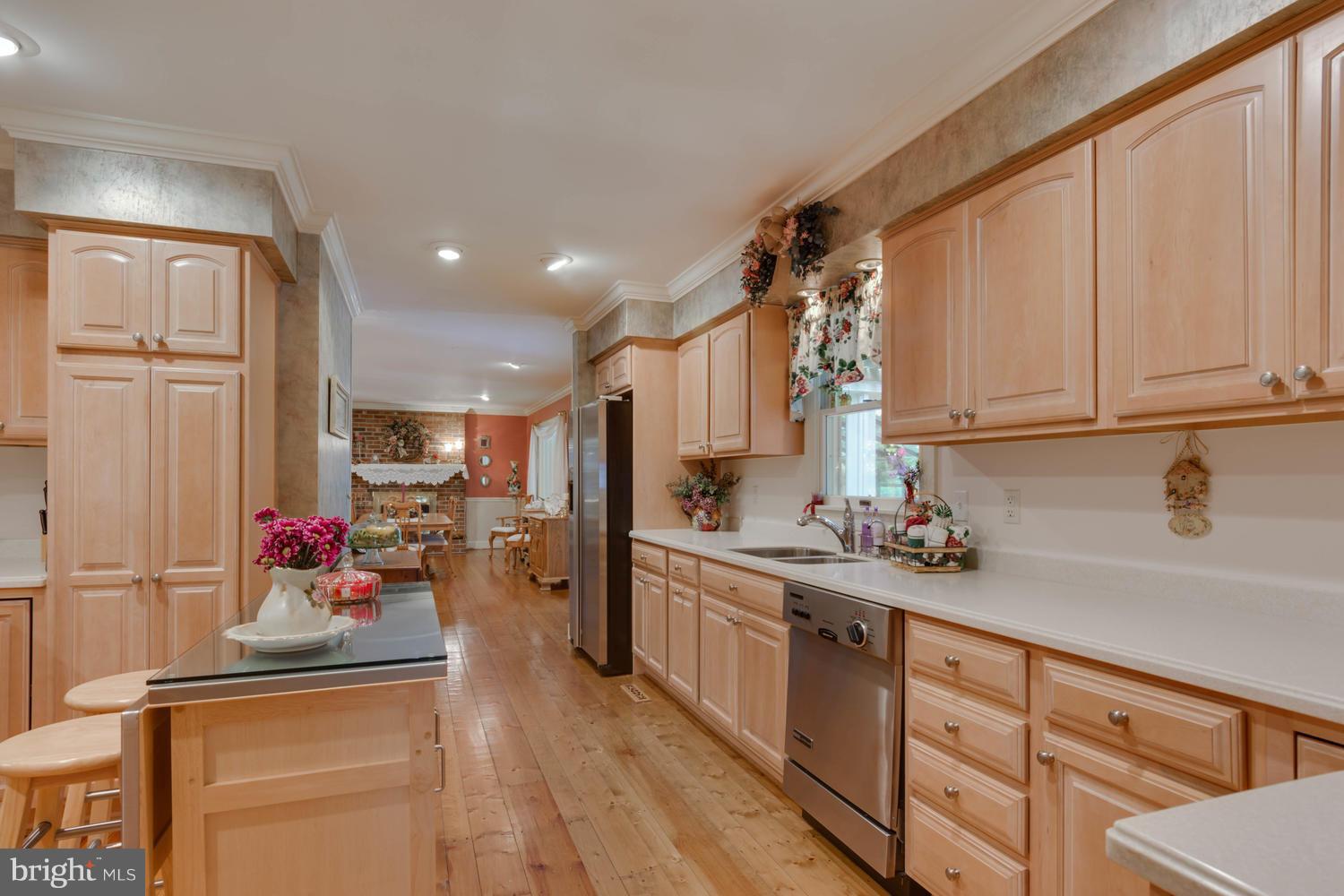7301 Solitude Road St. Michaels, MD 21663 - Photo 22 of 30 a kitchen with a sink stove and cabinets