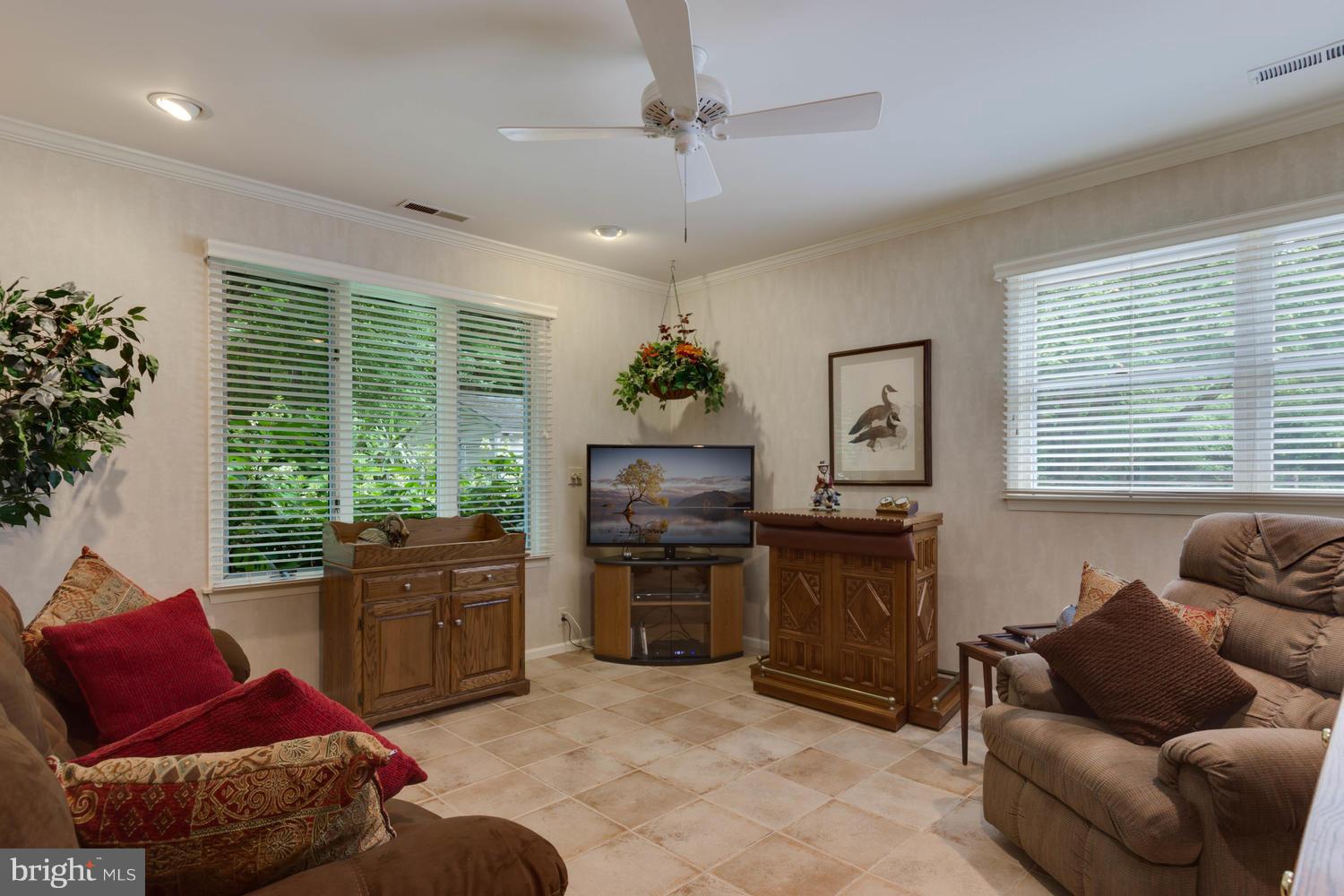 7301 Solitude Road St. Michaels, MD 21663 - Photo 24 of 30 a living room with furniture ceiling fan and a window