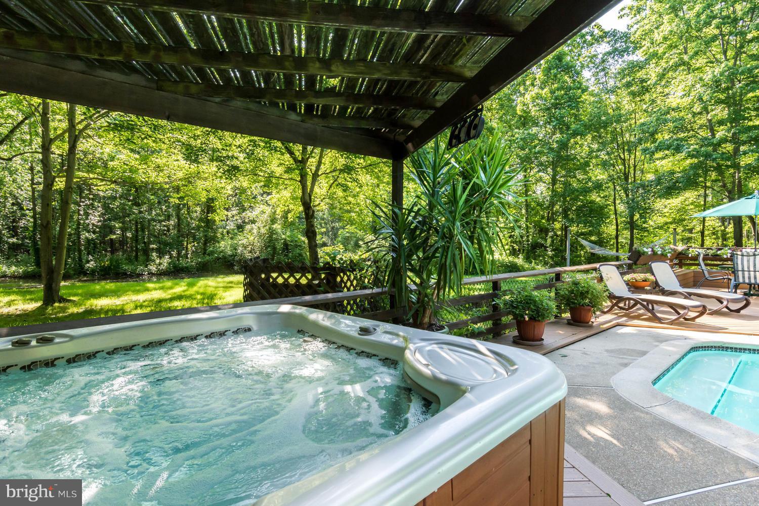 7301 Solitude Road St. Michaels, MD 21663 - Photo 8 of 30 a view of a swimming pool with a patio and a yard