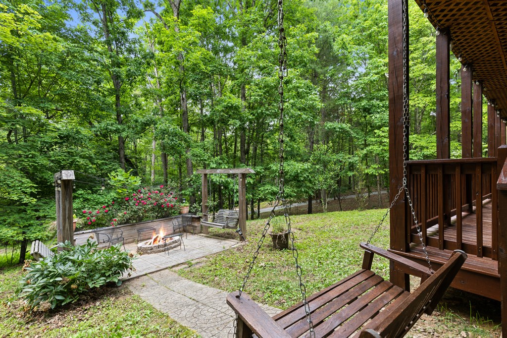220 Solar Drive Blue Ridge, GA 30513 - Photo 56 of 59 a view of a wooden deck with chairs and a yard