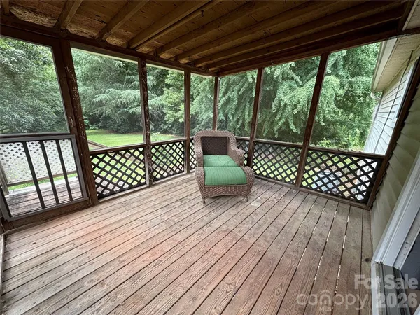 a front view of a house with a tree