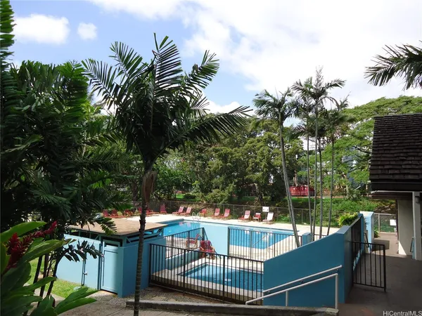 a view of house with outdoor seating and trees