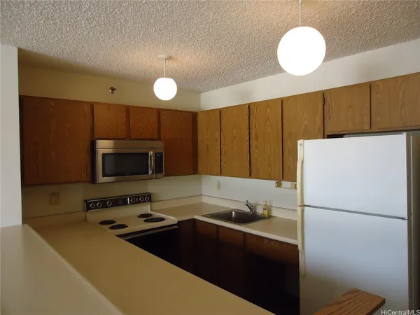 a kitchen with a refrigerator sink and cabinets