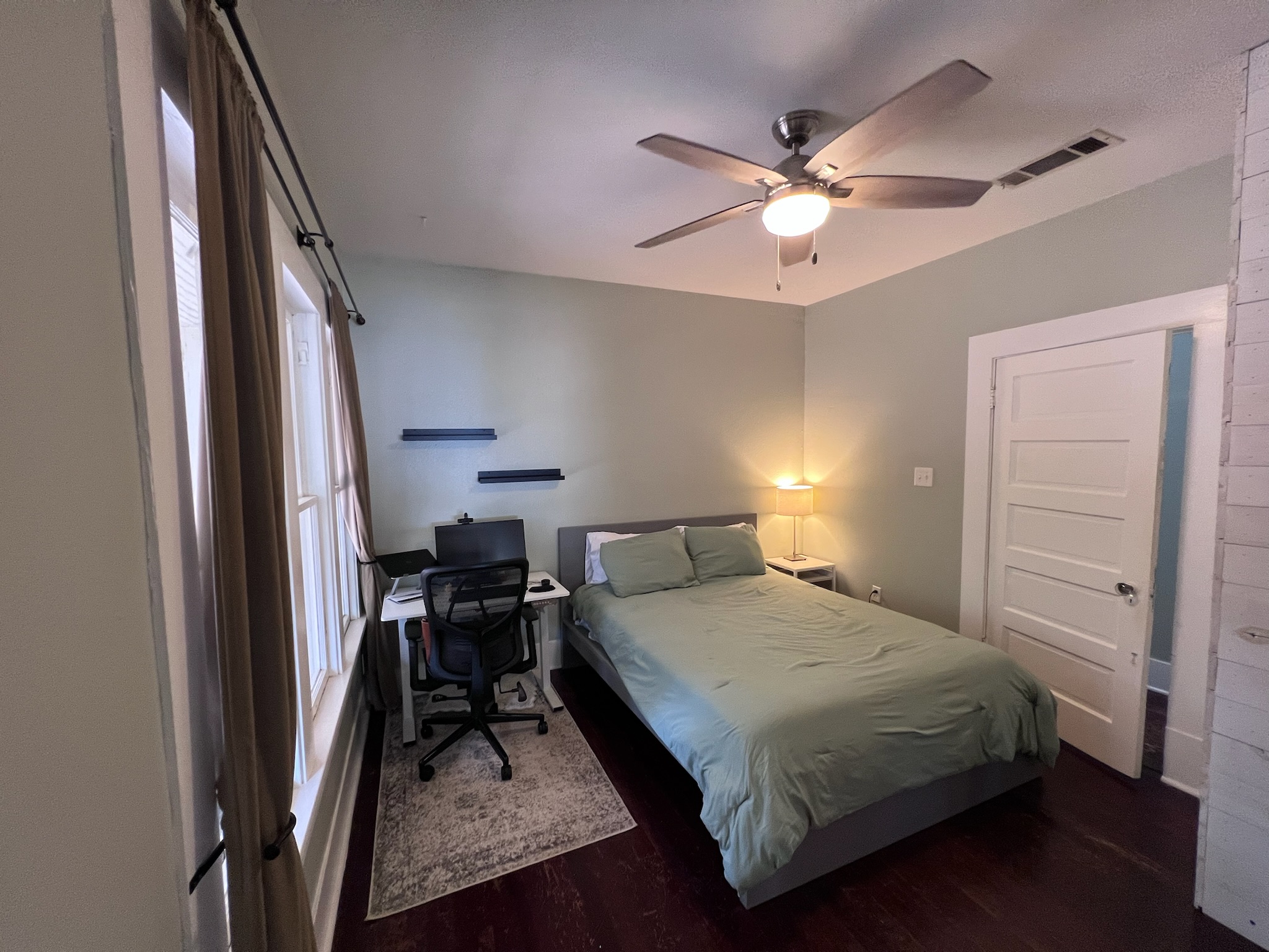307 East 35th Street, Unit A Austin, TX 78705 - Photo 19 of 31 Hardwood flooring and ample natural light define this cozy bedroom with a desk.