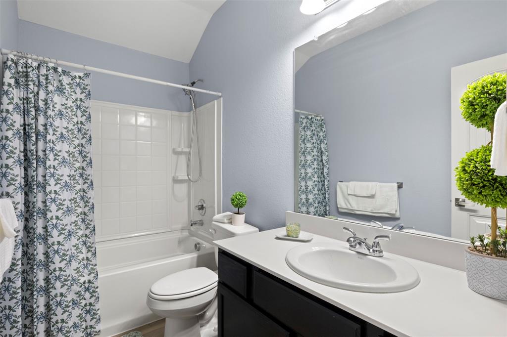 1318 Exeter Avenue Dallas, TX 75216 - Photo 12 of 31 a bathroom with a sink toilet and shower