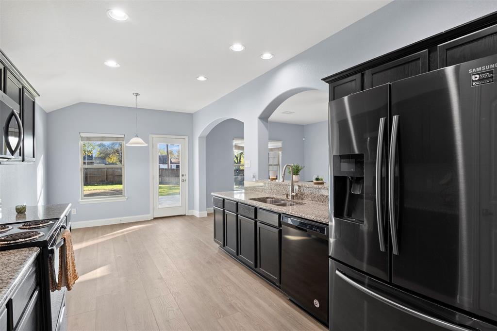 1318 Exeter Avenue Dallas, TX 75216 - Photo 24 of 31 a kitchen with stainless steel appliances granite countertop a refrigerator and a stove top oven