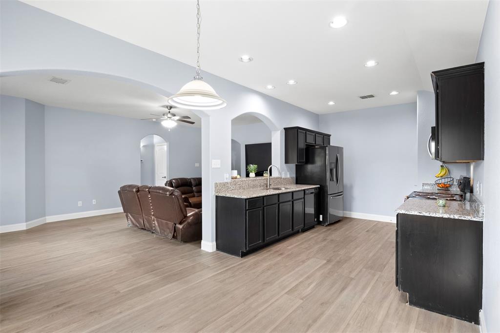 1318 Exeter Avenue Dallas, TX 75216 - Photo 30 of 31 a large room with a large counter top space a flat screen tv and kitchen view