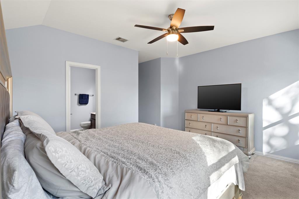 1318 Exeter Avenue Dallas, TX 75216 - Photo 26 of 31 a bedroom with a bed and a flat screen tv