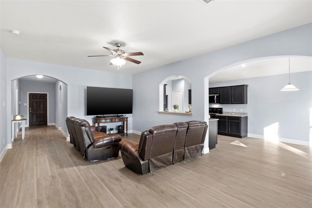 1318 Exeter Avenue Dallas, TX 75216 - Photo 6 of 31 a living room with furniture a flat screen tv and a fireplace