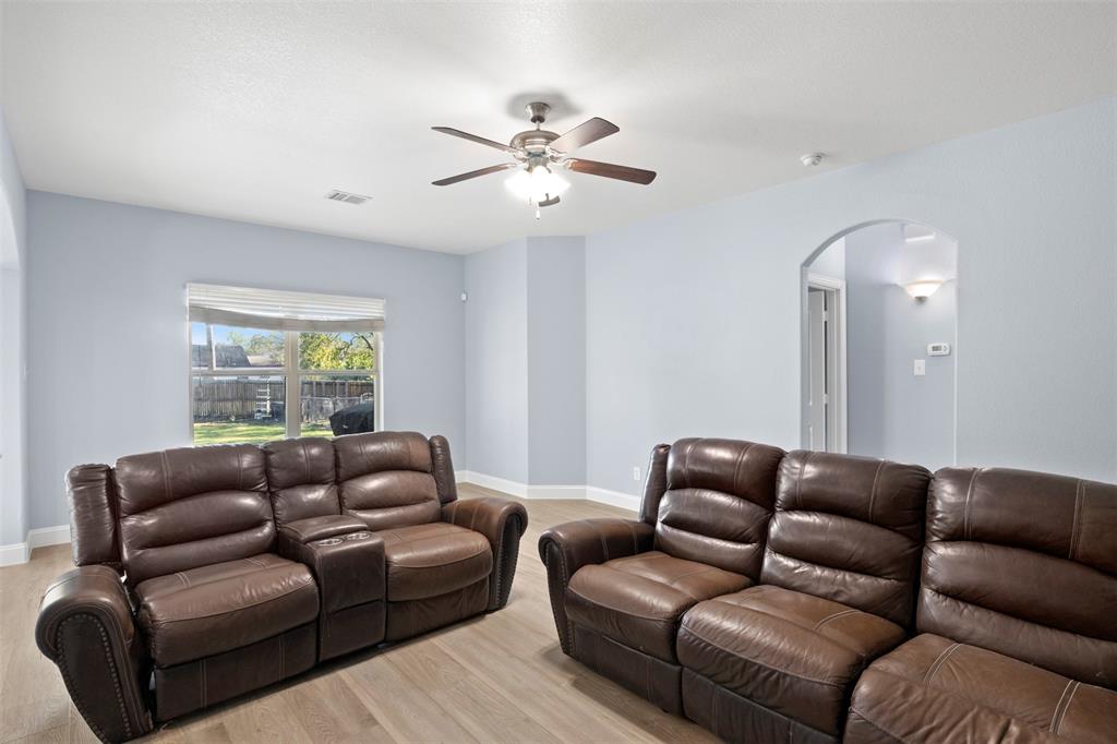 1318 Exeter Avenue Dallas, TX 75216 - Photo 7 of 31 a living room with furniture ceiling fan and a window