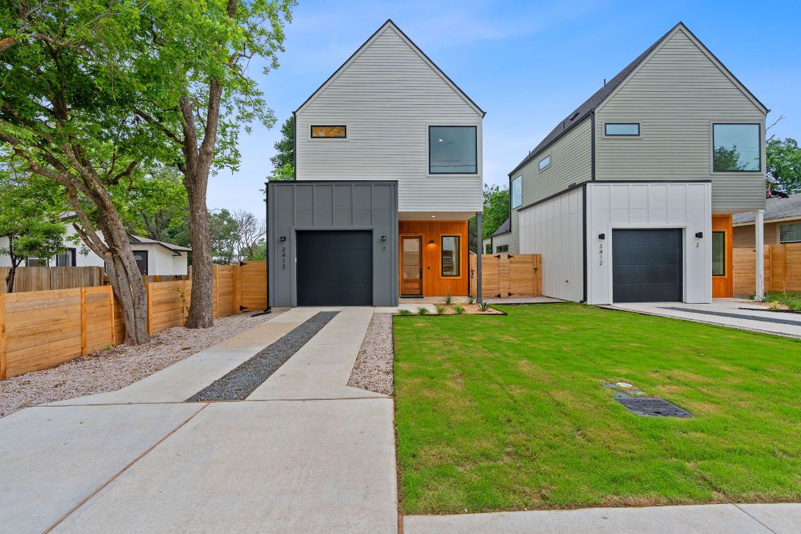 3412 Blumie Street, Unit 1 Austin, TX 78745 - Photo 1 of 39 Modern home with board and batten siding, concrete driveway, and a garage