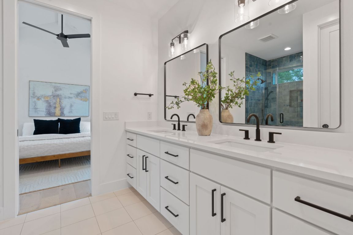 3412 Blumie Street, Unit 1 Austin, TX 78745 - Photo 20 of 39 Full bath with a shower stall, double vanity, light tile patterned floors, and a ceiling fan