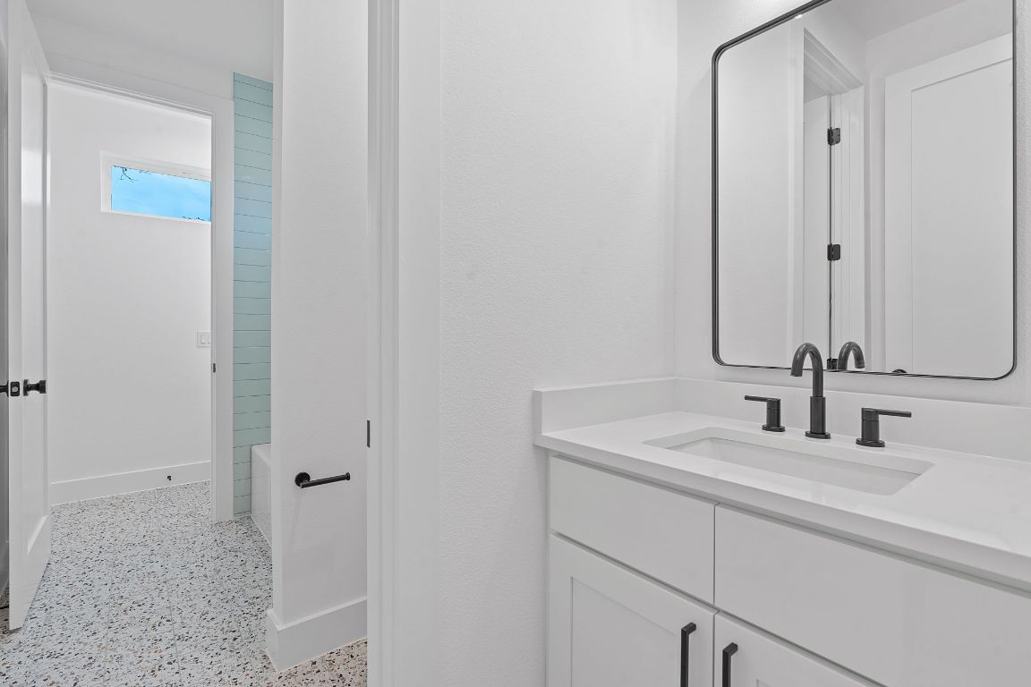 3412 Blumie Street, Unit 1 Austin, TX 78745 - Photo 25 of 39 Full bath with dark aggregate flooring and vanity