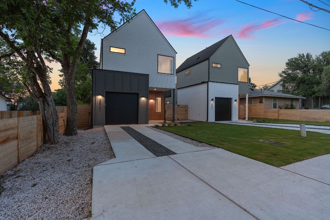 3412 Blumie Street, Unit 1 Austin, TX 78745 - Photo 36 of 39 Modern home with concrete driveway, a garage, and board and batten siding