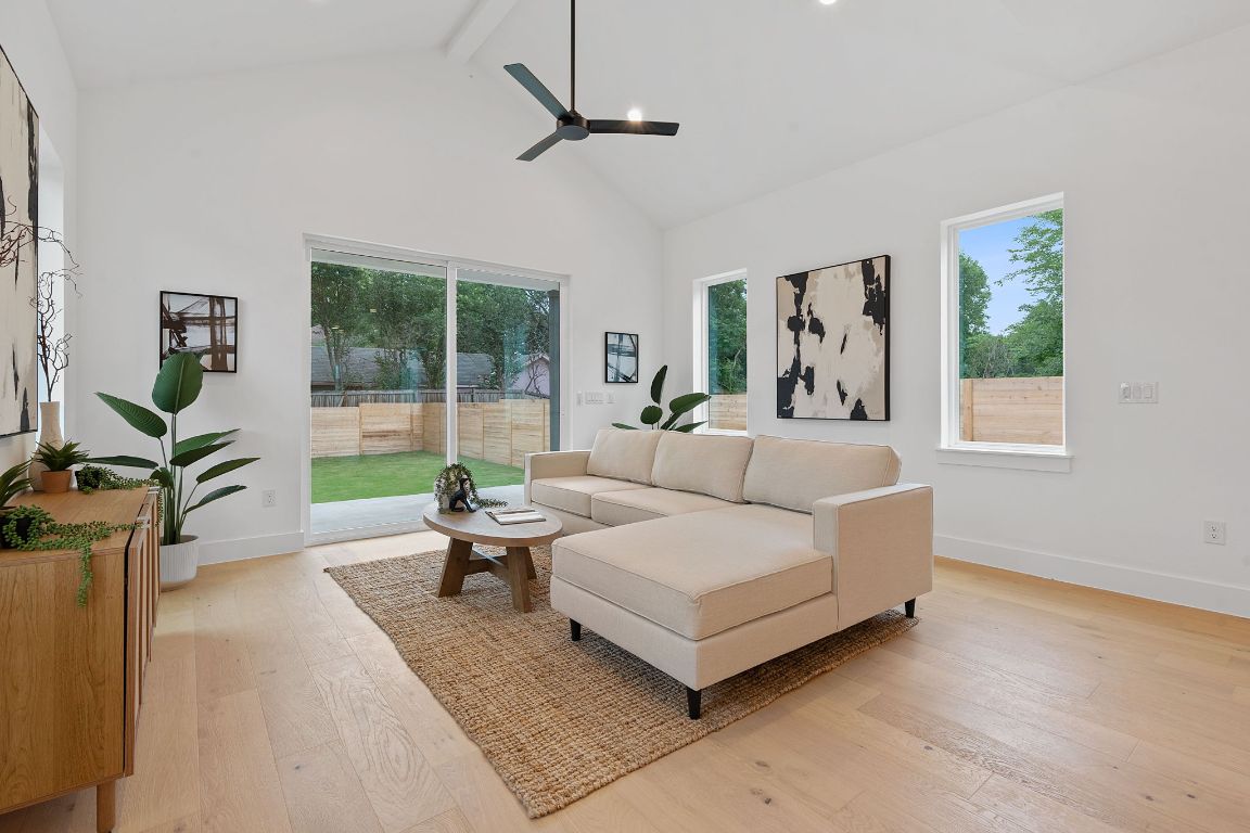 3412 Blumie Street, Unit 1 Austin, TX 78745 - Photo 5 of 39 Living area featuring beamed ceiling, light wood-type flooring, plenty of natural light, high vaulted ceiling, and a ceiling fan