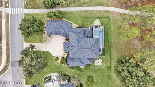 an aerial view of a house with a yard
