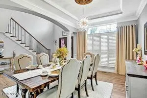 a view of a dining room with furniture window and wooden floor