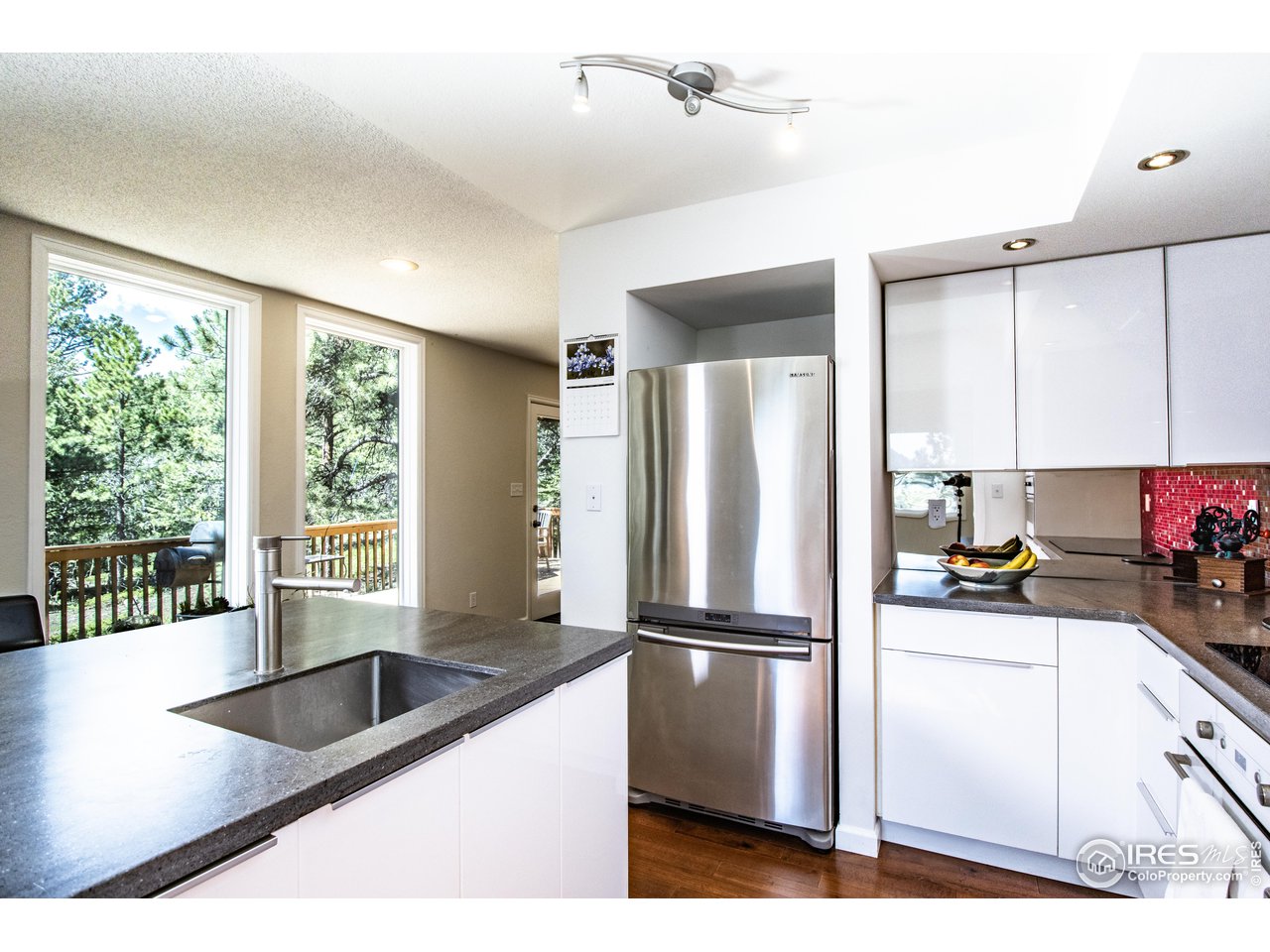 418 Ridge Road Ward, CO 80481 - Photo 14 of 36 a kitchen with a refrigerator a sink and cabinets