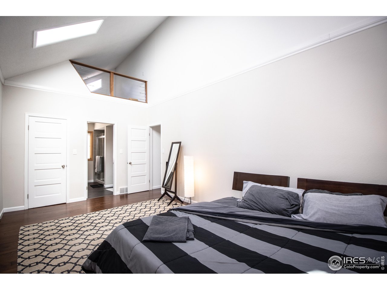 418 Ridge Road Ward, CO 80481 - Photo 18 of 36 a bedroom with a bed and wooden floor