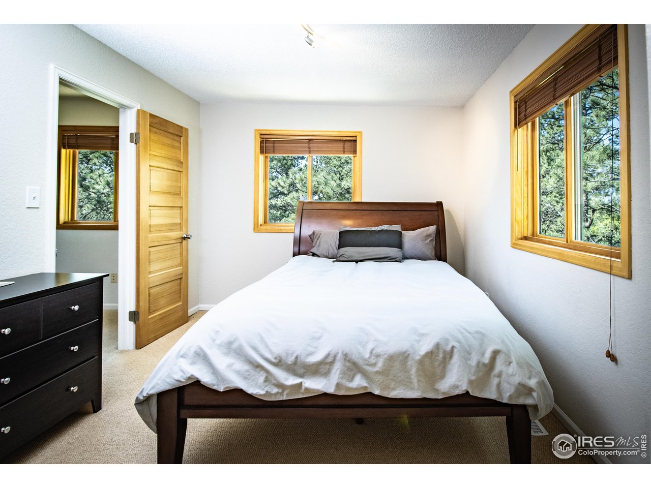 418 Ridge Road Ward, CO 80481 - Photo 21 of 36 a bedroom with a bed and a window