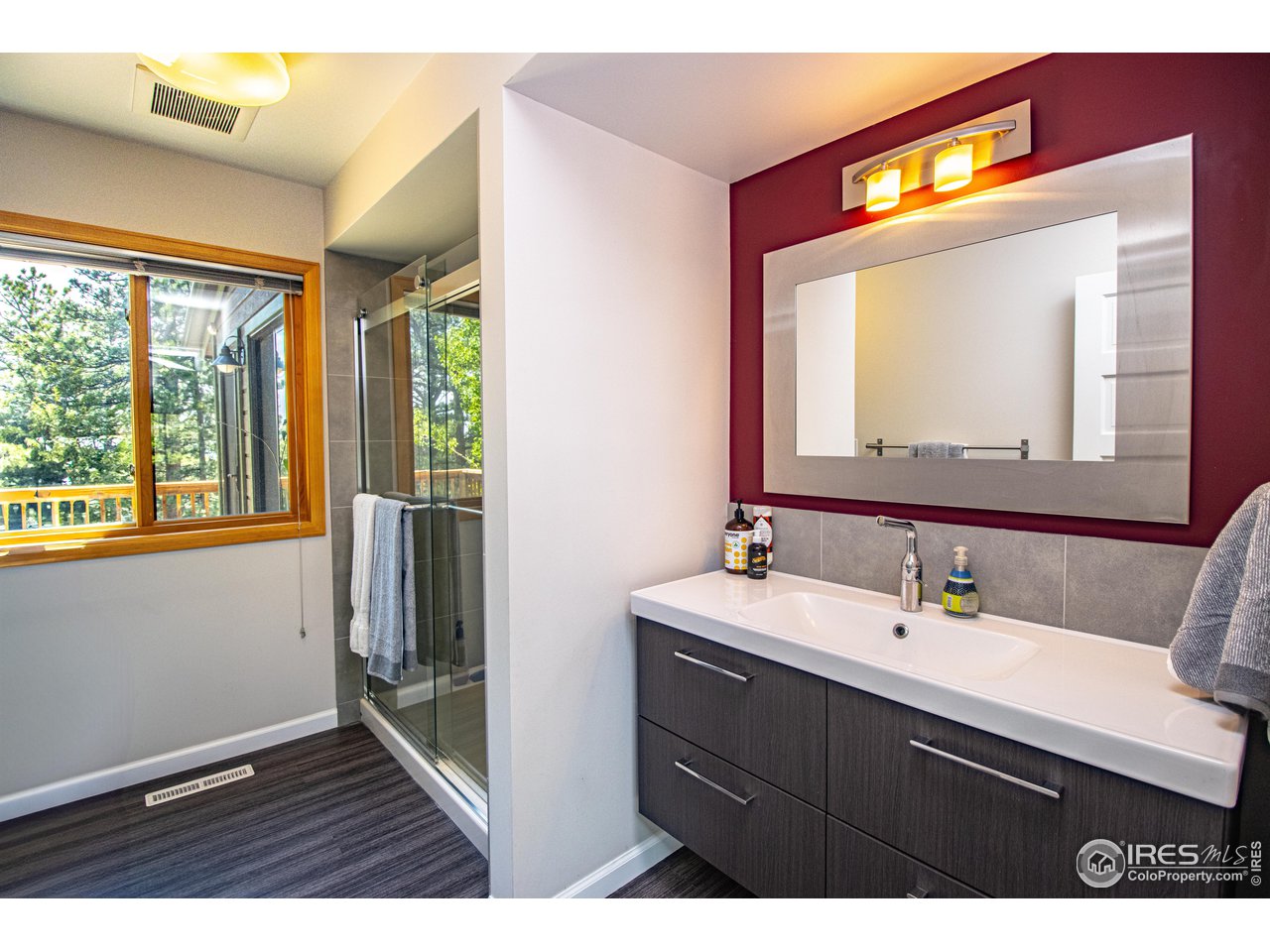418 Ridge Road Ward, CO 80481 - Photo 25 of 36 a bathroom with a sink a large mirror and a window