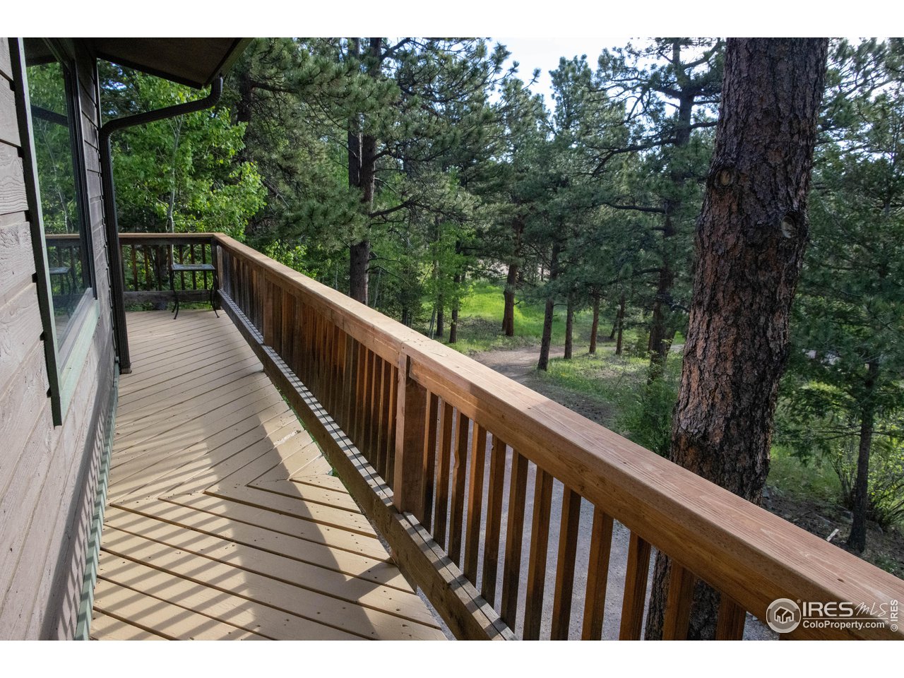 418 Ridge Road Ward, CO 80481 - Photo 4 of 36 a view of balcony with wooden floor and fence