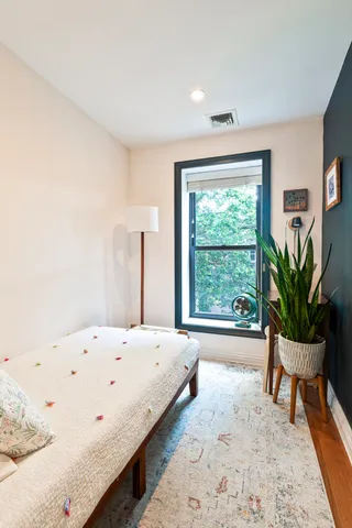 a bedroom with a bed and a table