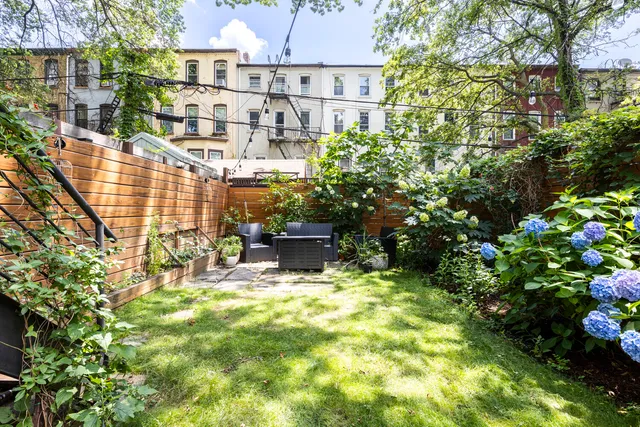 a balcony with wooden floor and outdoor seating