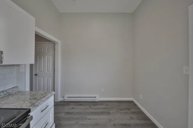 a view of wooden floor and cabinets in a room
