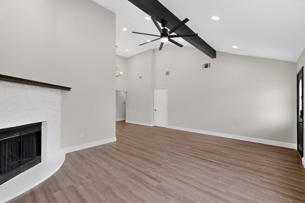 7729 Misty Ridge Drive North Fort Worth, TX 76137 - Photo 5 of 30 wooden floor in an empty room with a fireplace