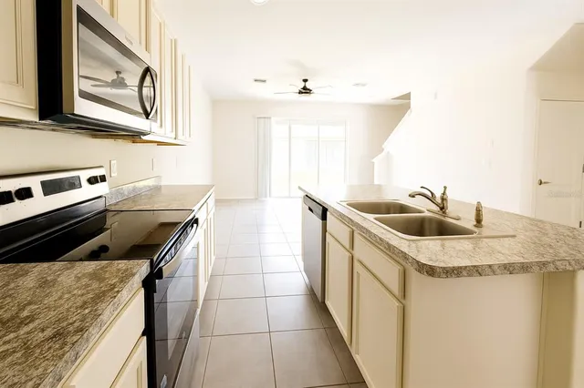 a kitchen that has a sink and a stove