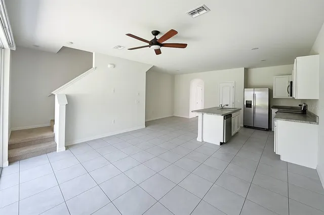a view of a kitchen with a sink and a refrigerator