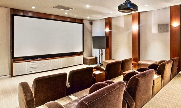 655 West Irving Park Road, Unit 2509 Chicago, IL 60613 - Photo 18 of 20 a media room with lots of chairs and a projector screen