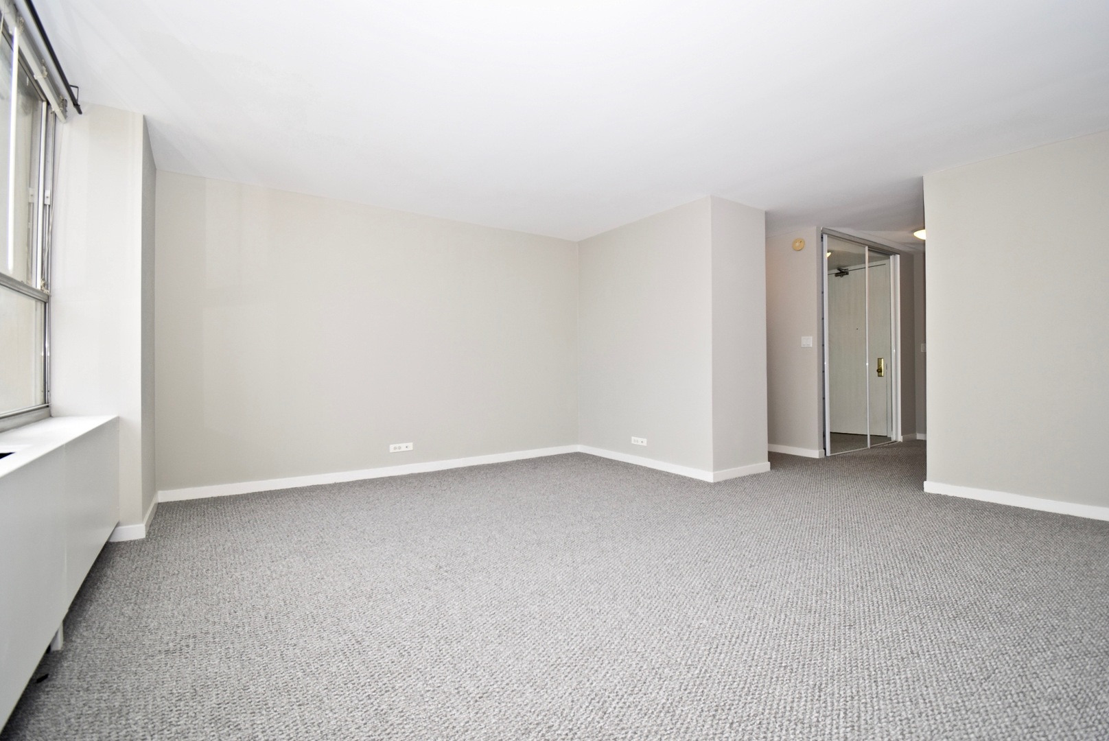 655 West Irving Park Road, Unit 2509 Chicago, IL 60613 - Photo 3 of 20 a view of an empty room with a window