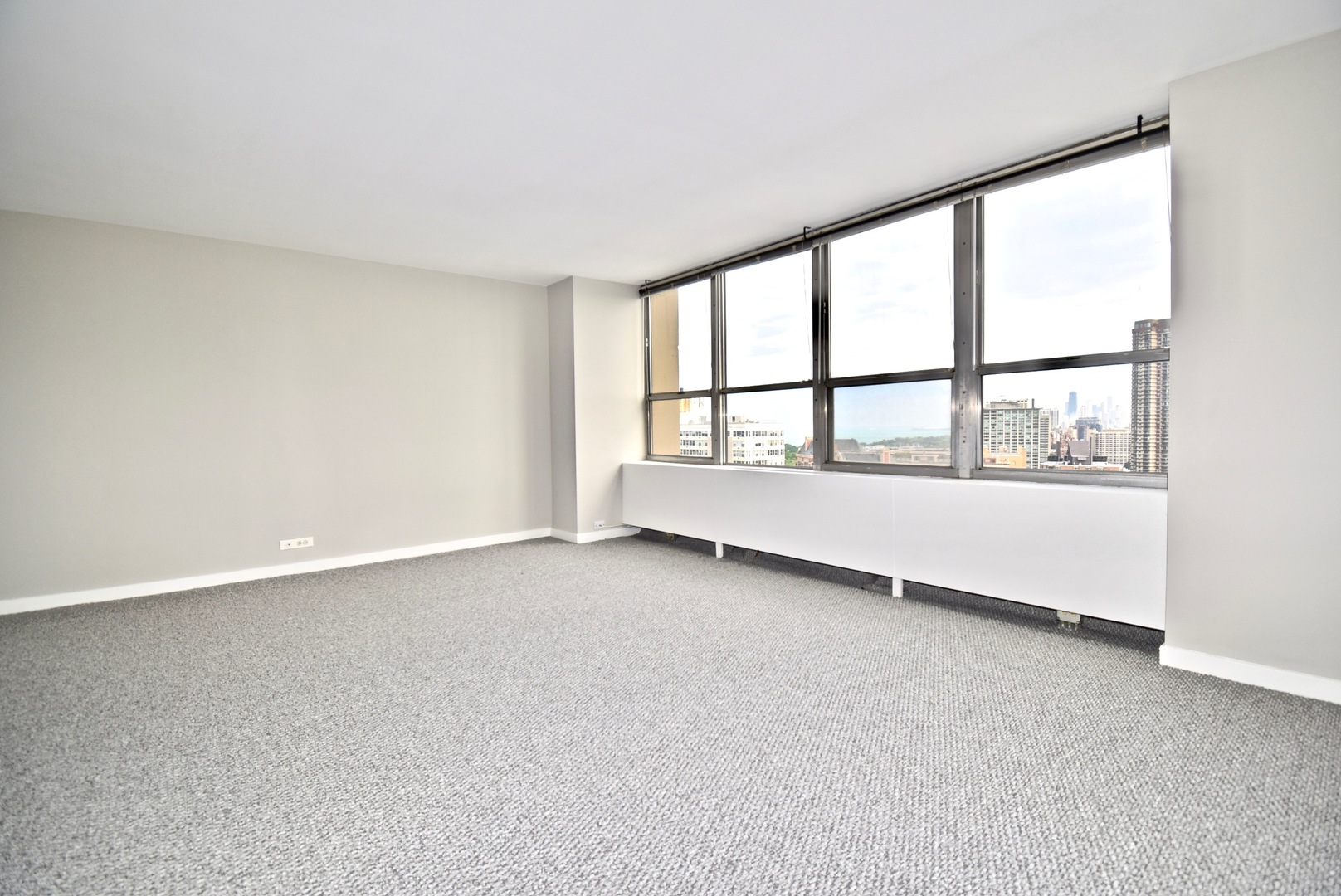 655 West Irving Park Road, Unit 2509 Chicago, IL 60613 - Photo 6 of 20 an empty room with large windows