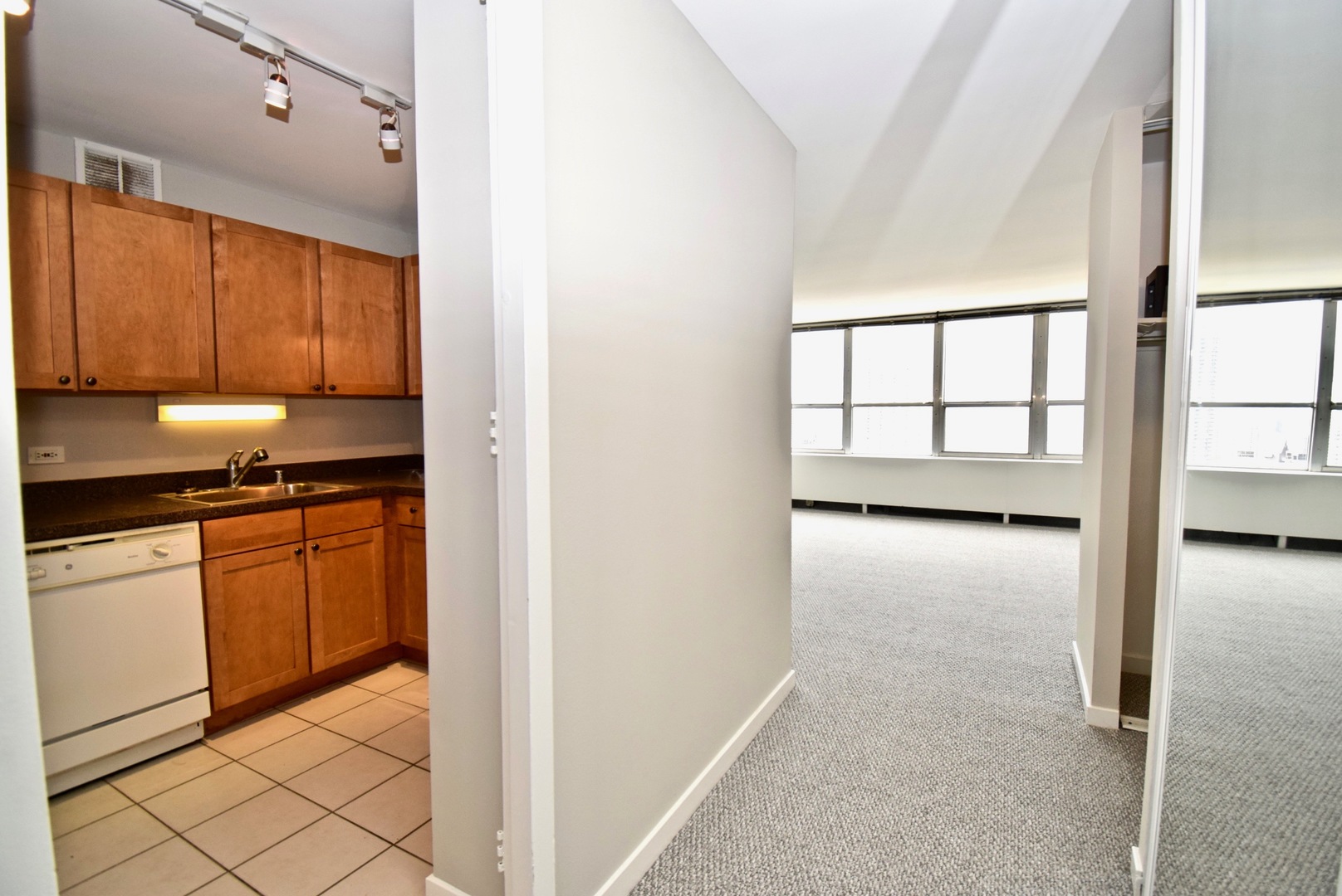 655 West Irving Park Road, Unit 2509 Chicago, IL 60613 - Photo 8 of 20 a kitchen with granite countertop white cabinets and a refrigerator