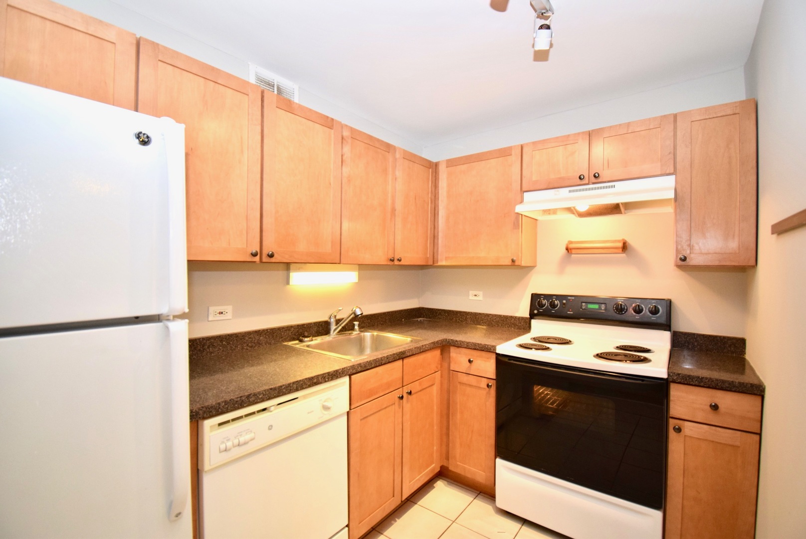 655 West Irving Park Road, Unit 2509 Chicago, IL 60613 - Photo 9 of 20 a kitchen with stainless steel appliances a stove a sink and a refrigerator