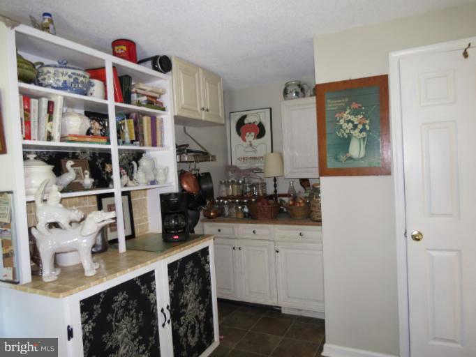 768 Johnsons Mill Road Berkeley Springs, WV 25411 - Photo 21 of 30 a kitchen with cabinets and window