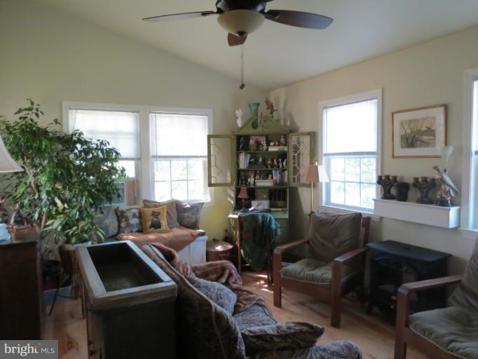 768 Johnsons Mill Road Berkeley Springs, WV 25411 - Photo 22 of 30 a living room with furniture and a window