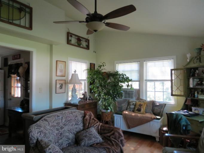 768 Johnsons Mill Road Berkeley Springs, WV 25411 - Photo 23 of 30 a bedroom with a bed window and couch