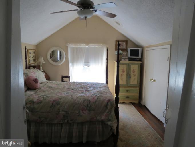 768 Johnsons Mill Road Berkeley Springs, WV 25411 - Photo 29 of 30 a bedroom with a bed and a chandelier