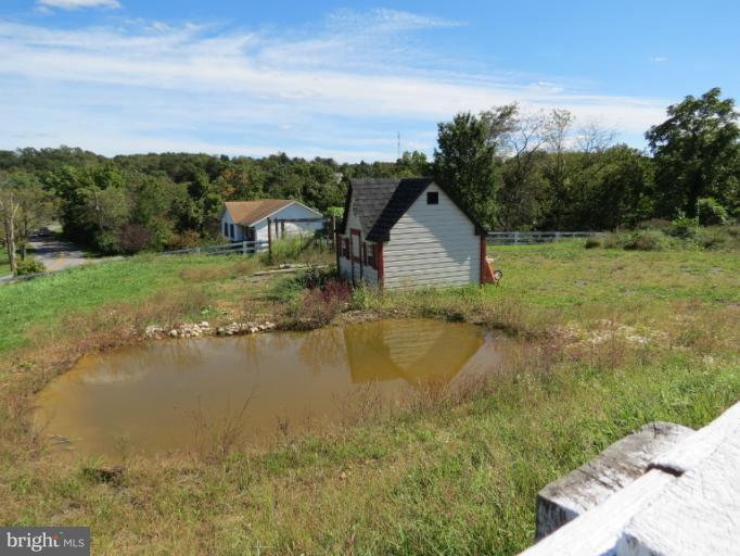 768 Johnsons Mill Road Berkeley Springs, WV 25411 - Photo 10 of 30 a view of a lake with a yard and mountain view